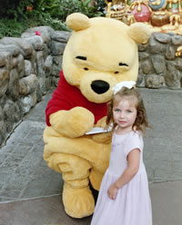 Winnie the Pooh signing his autograph.